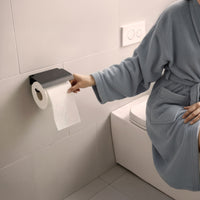 Wall mounted toilet paper holder with protective cover
